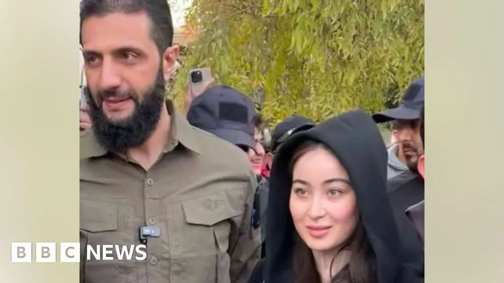 Syrian rebel leader dismisses controversy over photo with wife