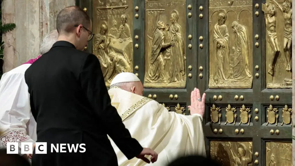 Pope Francis opens the Holy Door in St. Peter’s Basilica at the start of the special anniversary year