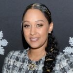 Tia Mowry says co-parenting on vacation can feel “lonely.”