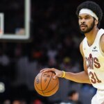 Jarrett Allen of the Cavs stuns fans with a reverse shot at halfcourt before the game