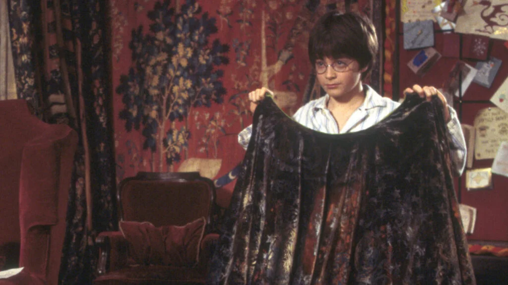 Who gave Harry Potter the Invisibility Cloak in the Philosopher’s Stone?